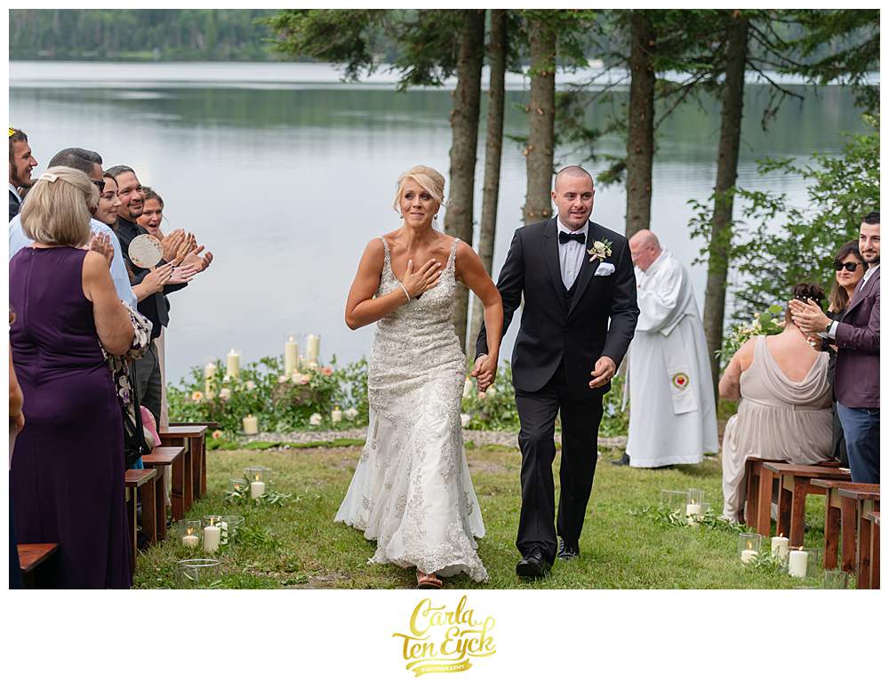 A bride gets emotional as she walks down the aisle at her New Hampshire wedding.