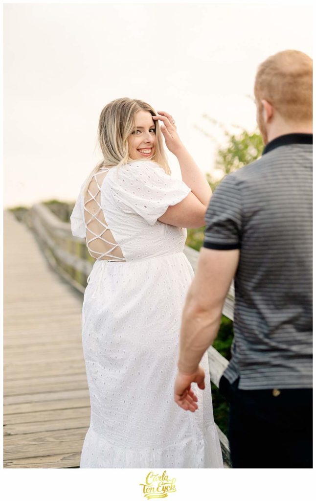 A bride walks down the boardwalk at Harkness during her wedding photo session in Waterford CT