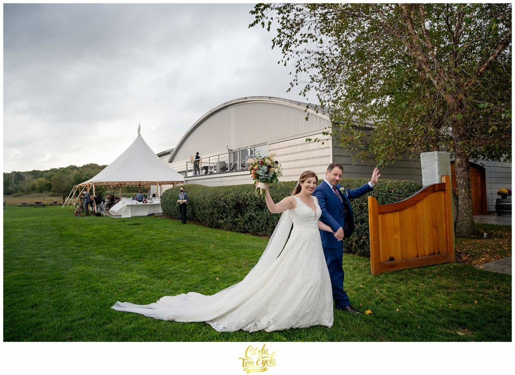 A bride and groom wave hello at their Saltwater Farm Wedding in Stonington CT