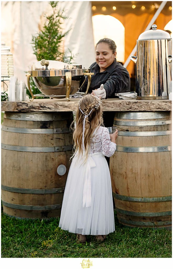 A flower girl gets a snack at a wedding at Van Wilgen's Garden Center in North Branford CT