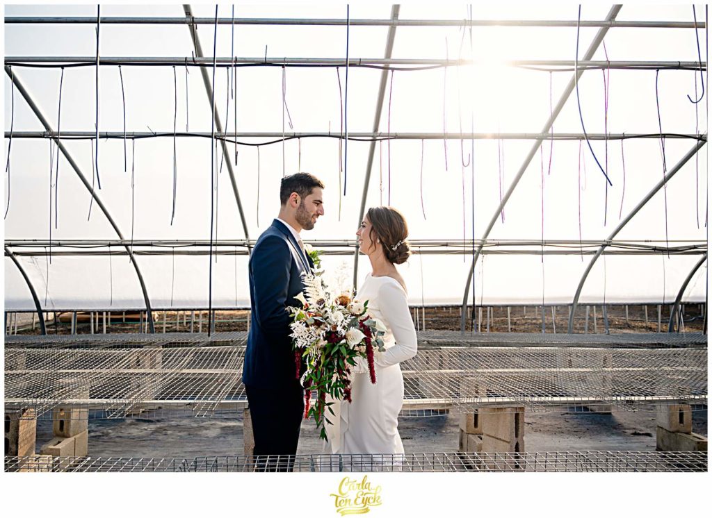 A bride and groom pose for photos at their wedding at Van Wilgen's Garden Center in North Branford CT