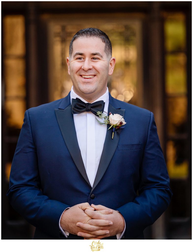 A groom during his first look at his winter Lord Thompson Manor wedding in Thompson CT