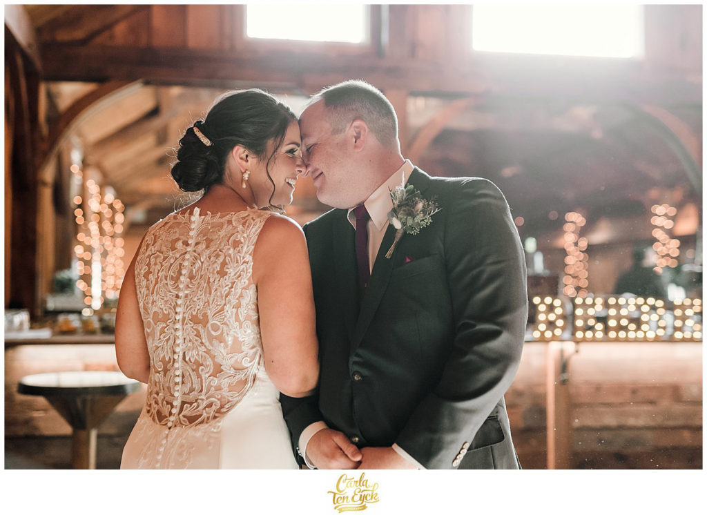 A bride and groom kiss at their wedding at The Barns at Wesleyan Hills in Middletown CT