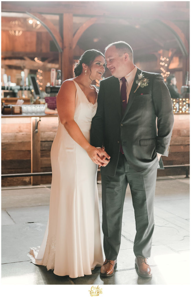 A bride and groom snuggle at their wedding at The Barns at Wesleyan Hills in Middletown CT
