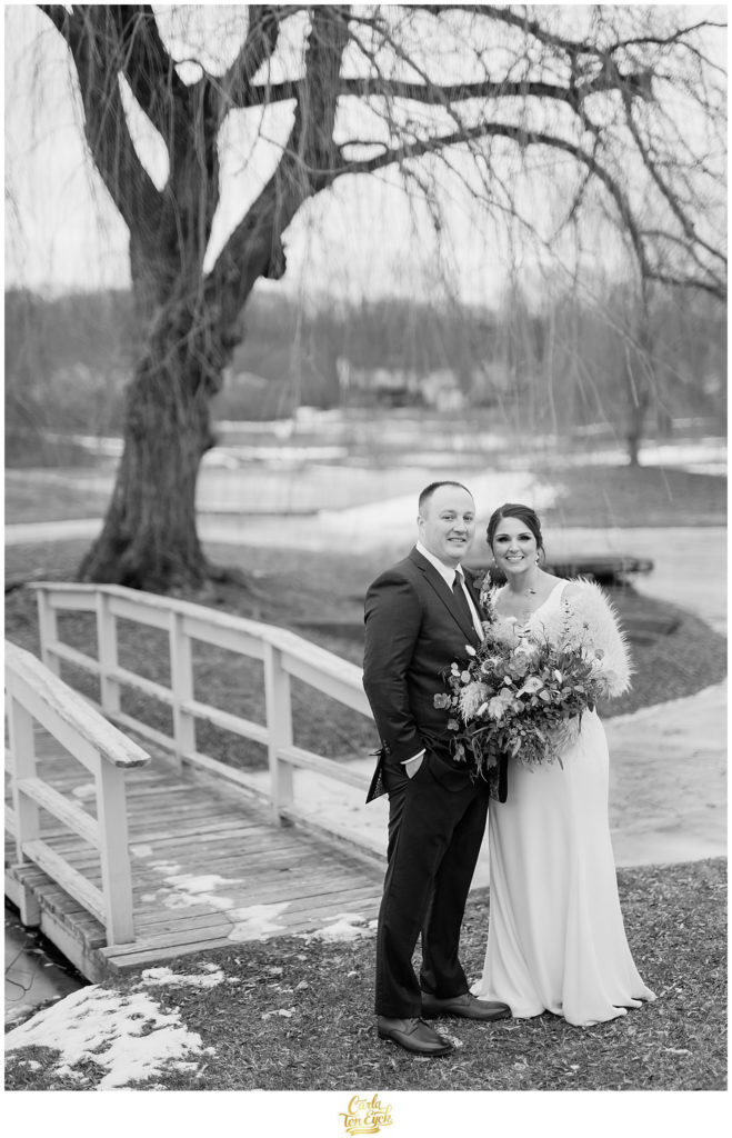 A bride and groom pose for photos at their wedding at The Barns at Wesleyan Hills in Middletown CT
