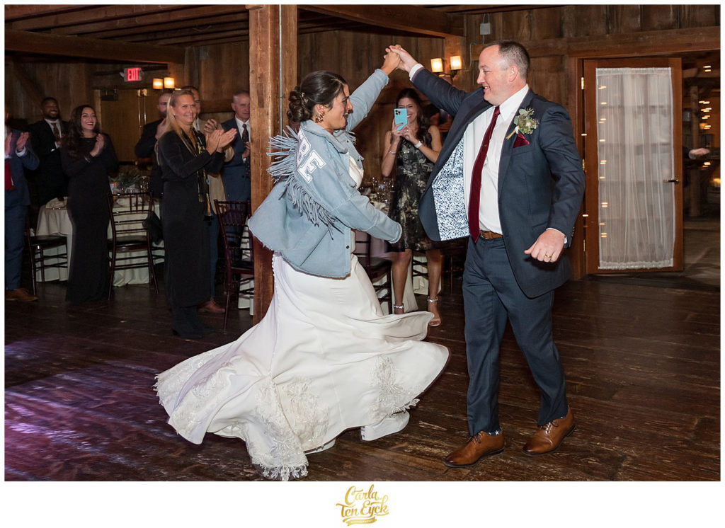 A bride and groom make their big entrance at their rustic wedding at The Barns at Wesleyan Hills in Middletown CT
