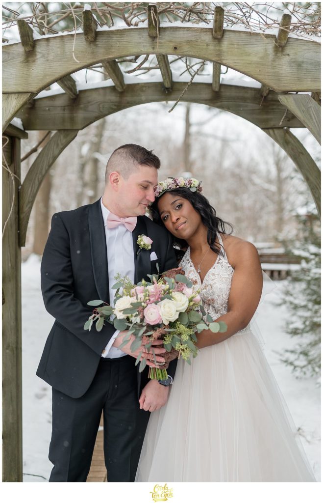 A couple snuggles during photos at their wedding at The Pavilion at Crystal Lake in Middletown, CT