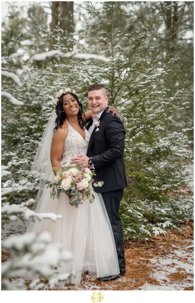 A couple poses for their wedding photos during their wedding at The Pavilion at Crystal Lake in Middletown, CT