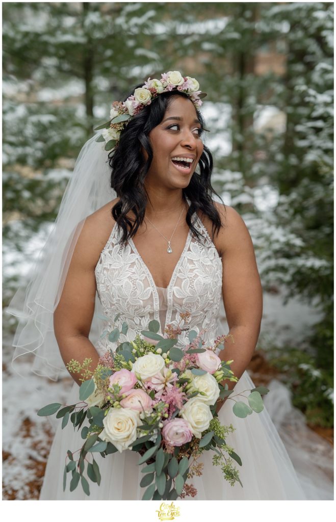 A bride laughs during photos for her wedding at The Pavilion at Crystal Lake in Middletown, CT