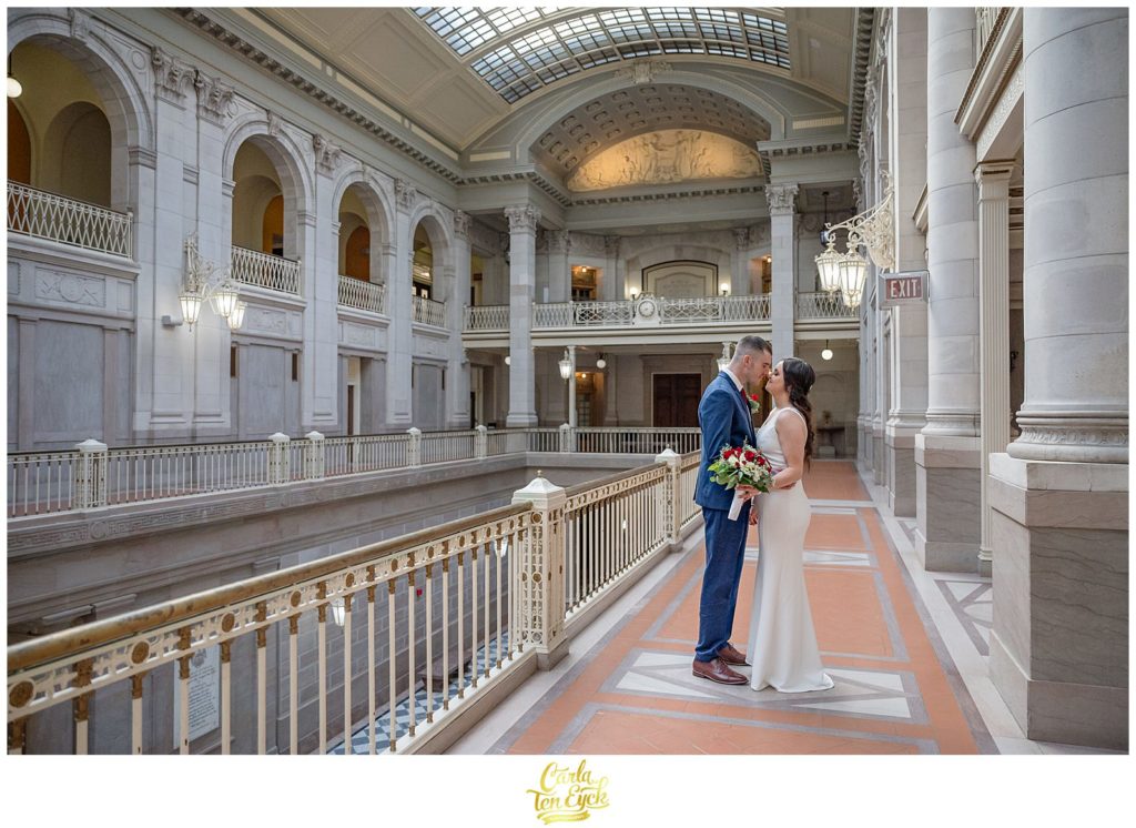 A bride and groom kiss during their Hartford City Hall Spring elopement, in Hartford CT