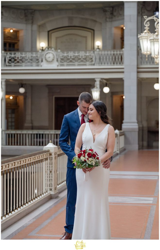 A newly wed couple embraces during their Hartford City Hall Spring elopement, in Hartford CT