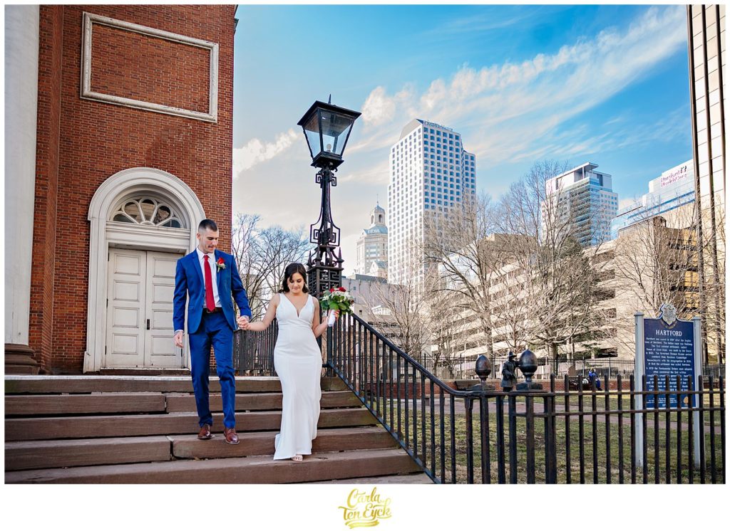 A bride and groom poke about downtown Hartford during their Hartford City Hall Spring elopement, in Hartford CT
