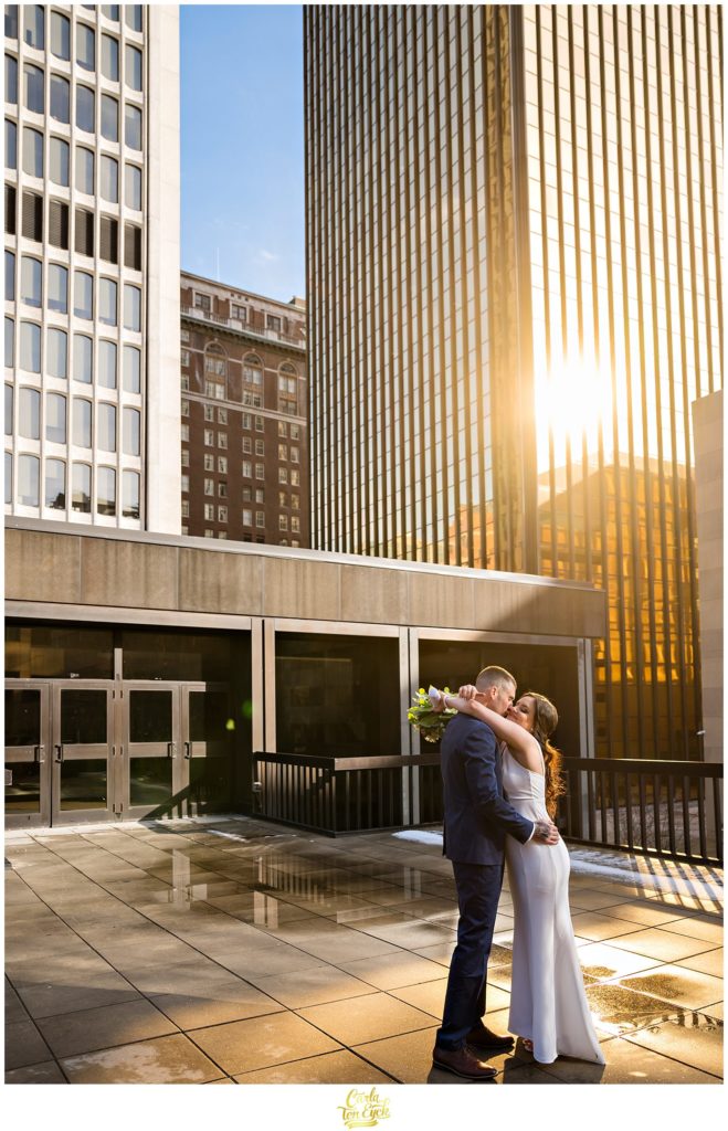 A bride and groom hug during their wedding photos at their Hartford City Hall Spring elopement, in Hartford CT