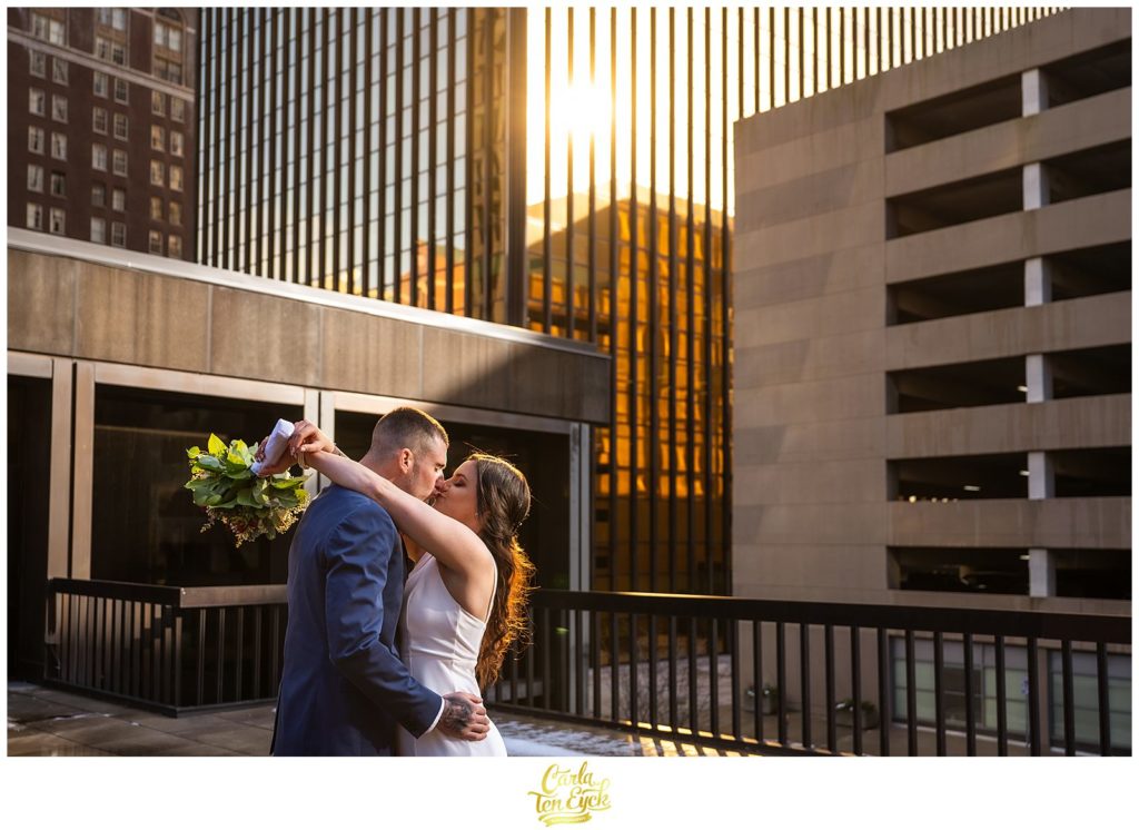 A bride and groom embrace during their Hartford City Hall Spring elopement