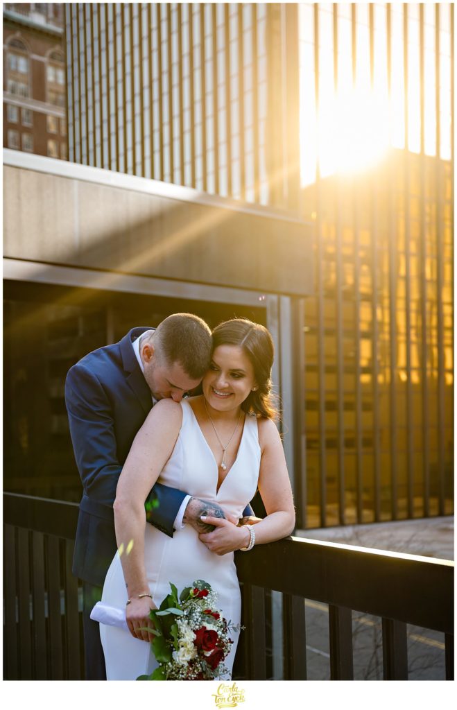 A bride and groom laugh during their wedding photos at their Hartford City Hall Spring elopement, in Hartford CT