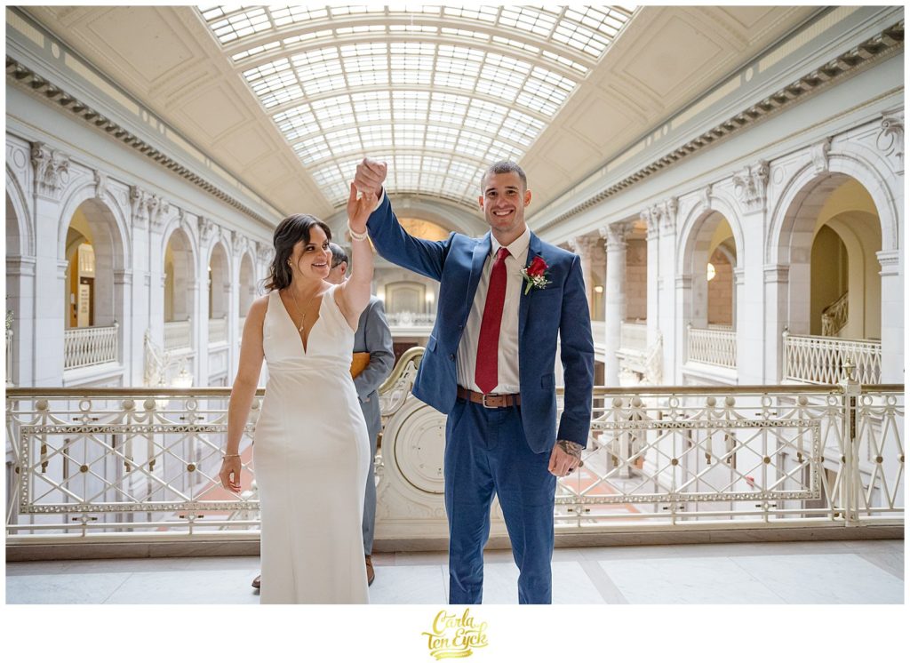 A bride and groom celebrate after their Hartford City Hall Spring elopement, in Hartford CT