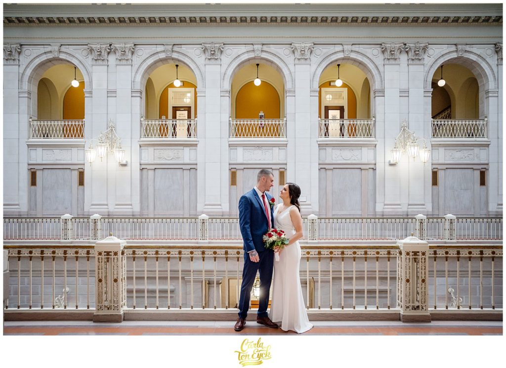 A bride and groom look at one another during wedding photos at their Hartford City Hall Spring elopement, in Hartford CT